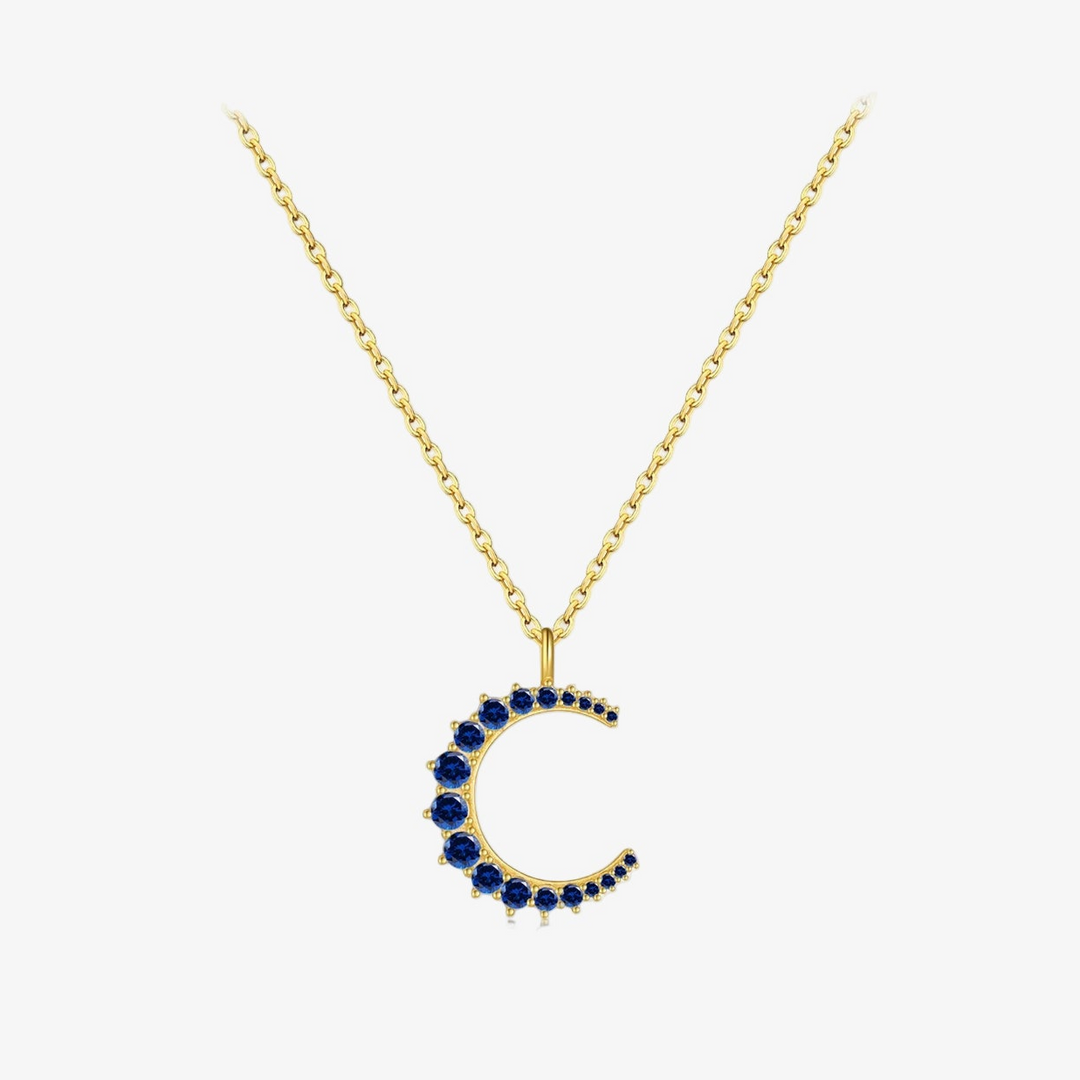 Gold necklace with a blue gemstone pendant